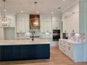 Gourmet kitchen with large island, stainless steel appliances, custom cabinets, and tile backsplash at 6120 Hutchins Dr, Buford, GA 30518