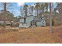 Charming light blue home features a two-car garage and a landscaped front yard at 670 Westbrook Pl, Lawrenceville, GA 30044