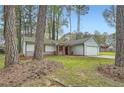 Charming single-Gathering home boasts a well-manicured front yard, driveway, and attached garage at 9053 Franklin Ct, Jonesboro, GA 30238