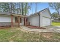 Charming single-Gathering home boasts a well-manicured front yard, driveway, and attached garage at 9053 Franklin Ct, Jonesboro, GA 30238