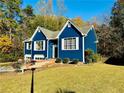 Beautiful blue home with well-kept lawn, mature trees and meticulous landscaping at 3337 Camens Way, Buford, GA 30519