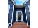 Close-up of the front door with sidelights and brick steps, framed by elegant white trim at 3337 Camens Way, Buford, GA 30519