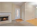 Cozy living room featuring a fireplace, neutral paint, and a front door with oval window at 460 Tribble Gap Rd # 1004, Cumming, GA 30040