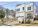 Contemporary two-story house with a garage, stone accents, and landscaping at 2020 Bixby Se St, Atlanta, GA 30317