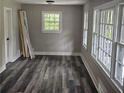 Bright bedroom with new flooring, large windows, and freshly painted walls at 1956 Shirley Sw St, Atlanta, GA 30311