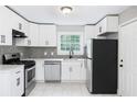 Modern kitchen featuring white cabinets, stainless steel appliances, and tile backsplash at 1956 Shirley Sw St, Atlanta, GA 30311