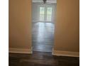 View through doorway into bright living room with doors to back patio and ceiling fan at 1956 Shirley Sw St, Atlanta, GA 30311