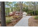 This home features an attached two-car garage with a long driveway and mature landscaping at 3595 Limberlost Sw Trl, Stockbridge, GA 30281