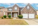 Beautiful brick home with a two-car garage, trimmed bushes, and a charming covered front porch at 3019 Iona Ct, Snellville, GA 30039