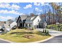 Two-story home with a combination of white and black siding, a three-car garage, and a well-manicured lawn at 4835 Fields Bridge Rd, Cumming, GA 30028