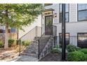 Inviting home entrance with brick stairs and black railing leading to the front door at 2026 Manchester Ne St, Atlanta, GA 30324