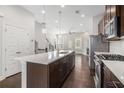 Modern kitchen with stainless steel appliances, large island with sink, and dark wood cabinets at 2026 Manchester Ne St, Atlanta, GA 30324