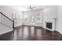 Bright living room featuring a fireplace, gleaming hardwood floors, and large windows at 2026 Manchester Ne St, Atlanta, GA 30324