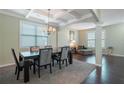A dining room featuring coffered ceilings, lots of light, and space for entertaining guests at 1252 Thomas Daniel Way, Lawrenceville, GA 30045