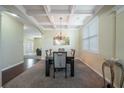 An expansive dining area featuring elegant lighting, coffered ceilings, and a neutral color scheme at 1252 Thomas Daniel Way, Lawrenceville, GA 30045