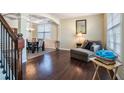 Bright living area featuring hardwood floors, neutral paint, and views into the dining room at 1252 Thomas Daniel Way, Lawrenceville, GA 30045