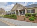 Beautiful home exterior with manicured landscaping and charming front porch at 241 Orchards Cir, Woodstock, GA 30188