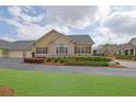 Inviting home featuring lush green lawns and meticulously maintained landscaping at 241 Orchards Cir, Woodstock, GA 30188