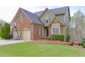 Beautiful two-story home boasts manicured lawn, lovely shrubbery, and a basketball hoop above the two-car garage at 3743 Southland Dr, Buford, GA 30519