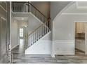 Welcoming foyer features soaring ceilings, hardwood floors, and a staircase leading to the upper level at 3743 Southland Dr, Buford, GA 30519
