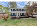Inviting two-story home with a well-manicured lawn and blossoming landscape at 1196 Oak Sw Rd, Lilburn, GA 30047