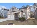 View of the home featuring a brick and siding exterior, two-car garage, and manicured lawn at 345 Caledonia Ct, Peachtree City, GA 30269