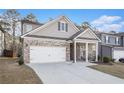 Charming single Gathering home featuring a brick and siding exterior, manicured lawn, and two-car garage at 345 Caledonia Ct, Peachtree City, GA 30269