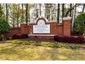 Beautiful entrance to Vining Estates featuring brick sign, manicured landscape, and colorful flower beds at 611 Vinings Estates Se Dr, Smyrna, GA 30126