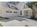 Expansive two-car garage showcasing carriage doors and exterior lighting, adding to the home's curb appeal at 52 25Th Nw St, Atlanta, GA 30309