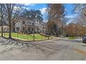 Neighborhood street view showcasing a beautifully landscaped corner lot with sidewalks and mature trees at 52 25Th Nw St, Atlanta, GA 30309
