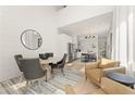 Elegant living room with dining area adjacent to a modern kitchen, great for entertaining at 10940 Serenbe Ln, Chattahoochee Hills, GA 30268
