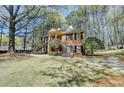 Classic brick home nestled amongst mature trees, featuring a covered entry and dual staircases at 30 Plantation Ne Dr # B, Atlanta, GA 30324