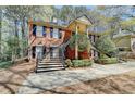 Exterior view of a brick home showcasing a unique dual staircase design leading to a covered entryway at 30 Plantation Ne Dr # B, Atlanta, GA 30324