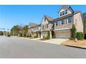 Attractive neighborhood street with well-maintained townhomes and manicured front yards at 3172 Havencroft Ne Dr, Roswell, GA 30075