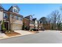 Street view of modern townhomes featuring brick and neutral siding with attached garages at 3172 Havencroft Ne Dr, Roswell, GA 30075