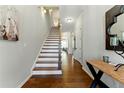 Inviting foyer with hardwood floors, staircase, and stylish decorative accents at 3172 Havencroft Ne Dr, Roswell, GA 30075