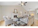 Bright living room with vaulted ceilings, fireplace, and stylish furniture, creating a cozy atmosphere at 7170 Highbrook E Cir, Cumming, GA 30041