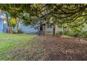 View of the inviting single-story home with mature trees surrounding the front yard at 1753 Beechwood Sw Blvd, Atlanta, GA 30311