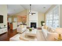 Bright living room featuring a fireplace, vaulted ceilings, hardwood floors, and modern white furnishings at 2368 Barrett Cottage # 17, Marietta, GA 30066