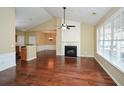 Spacious living room with hardwood floors, a fireplace, and large windows, seamlessly connecting to other rooms at 2368 Barrett Cottage # 17, Marietta, GA 30066