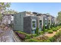 Modern townhome exterior featuring a brick facade, manicured landscaping, and a private walkway at 728 Oakview Rd, Decatur, GA 30030