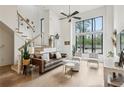 Bright living room boasting a staircase, ceiling fan, hardwood floors, and tall windows at 728 Oakview Rd, Decatur, GA 30030