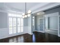 Dining room featuring hardwood floors, modern lighting, and adjacent doorways at 5712 Kendrick Ln, Cumming, GA 30041