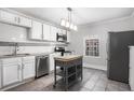 Bright kitchen featuring white cabinets, stainless steel appliances, and a central island at 972 Sims Nw Ave, Atlanta, GA 30318