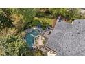 Aerial view of a backyard featuring a private pool, hot tub, deck and lush landscaping for relaxing outdoor living at 9985 High Falls Pointe, Johns Creek, GA 30022