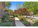 Well-maintained front yard with mature trees, shrubs and a stone walkway leading up to this lovely home at 9985 High Falls Pointe, Johns Creek, GA 30022