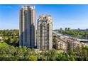 Exterior shot showcasing two modern high-rise condos with city views and lush greenery at 795 Hammond Dr # 1707, Atlanta, GA 30328