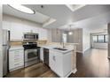 Bright kitchen featuring stainless steel appliances, white cabinetry, and sleek countertops at 795 Hammond Dr # 1707, Atlanta, GA 30328