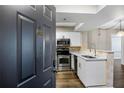 Modern kitchen with stainless steel appliances, white cabinets, and stylish finishes at 795 Hammond Dr # 1707, Atlanta, GA 30328