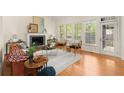 Cozy living room featuring a fireplace, hardwood floors and large windows at 1363 Brentwood Ln, Marietta, GA 30062